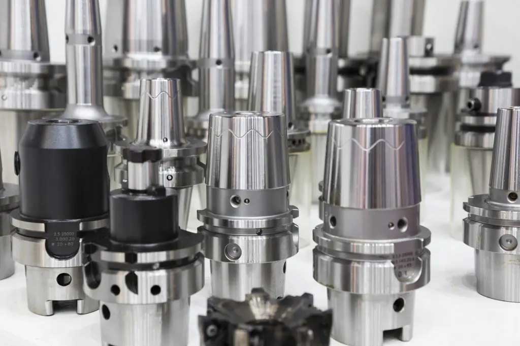 How do different types of CNC toolholders compare in terms of rigidity and tool clamping mechanisms?
